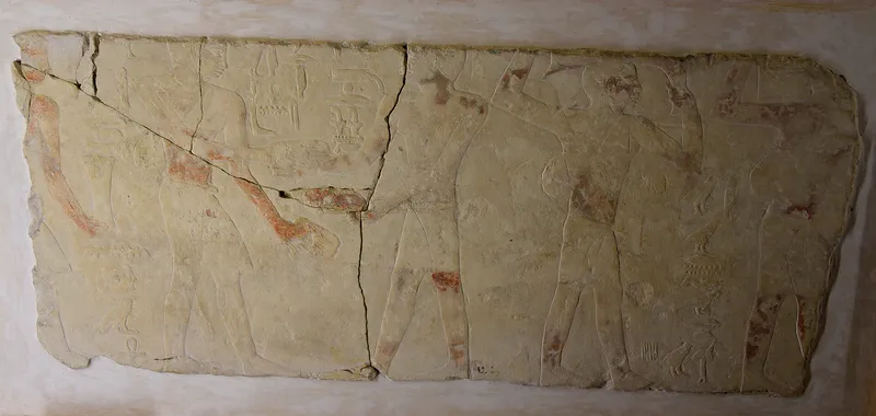 A faded market scene from a tomb at Saqqara, about 4,400 years old: in the middle, men trade sandals for grain. Petrie Museum, London.