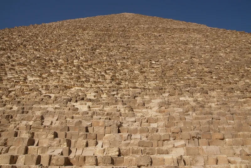 The side of the Great Pyramid of Khufu. Its smooth outer casing was taken away long ago, leaving steps of stone blocks.