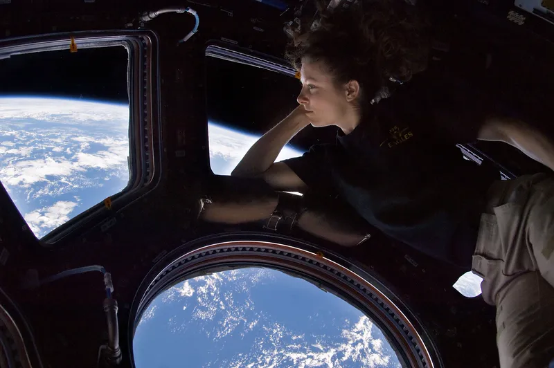 An astronaut looking out at Earth from the space station's Cupola, a favorite place for many crew members.