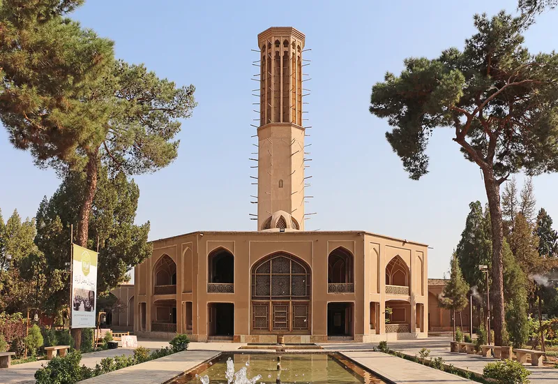 The tall windcatcher of Dowlatabad Garden in Yazd, Iran, which draws air through the building below.