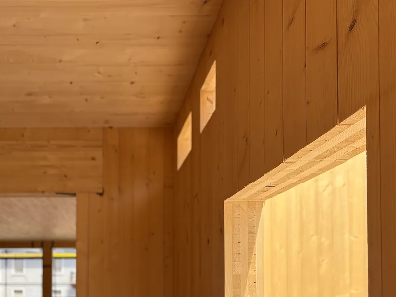 Cross-laminated timber panels forming the walls and ceiling of a building.