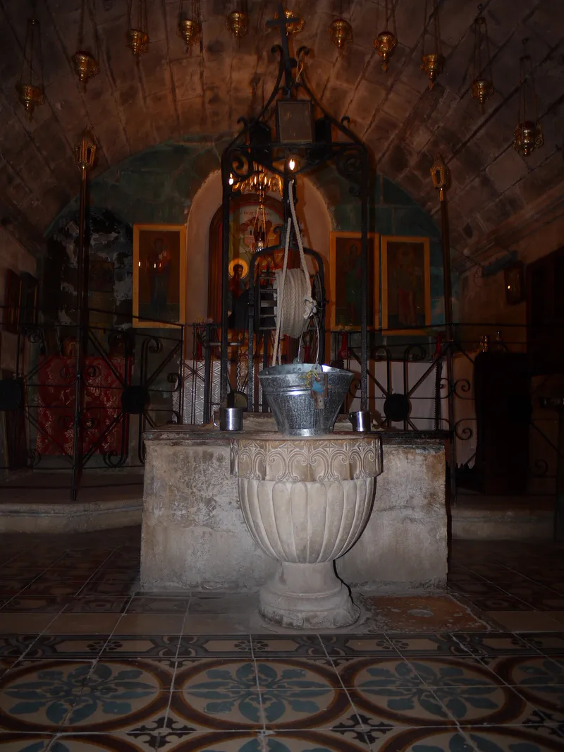 Jacob's Well today, in the crypt of a church in Nablus. Visitors still draw water from it with a bucket.