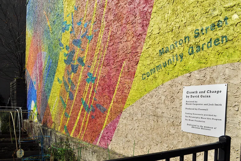 A colorful mural beside a community garden in Philadelphia.