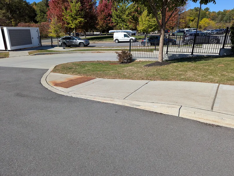 A curb ramp with tactile paving that blind and partially sighted people can feel underfoot.
